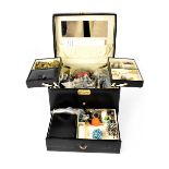 A large quantity of costume jewellery contained within a black vanity case to include rings,