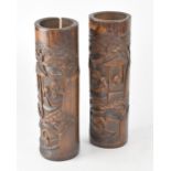 A pair of early 20th century bamboo brush pots, carved figural and village decoration,