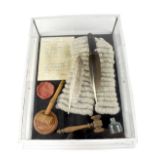 A wall hanging display case containing judiciary ephemera, a facsimile custody receipt,