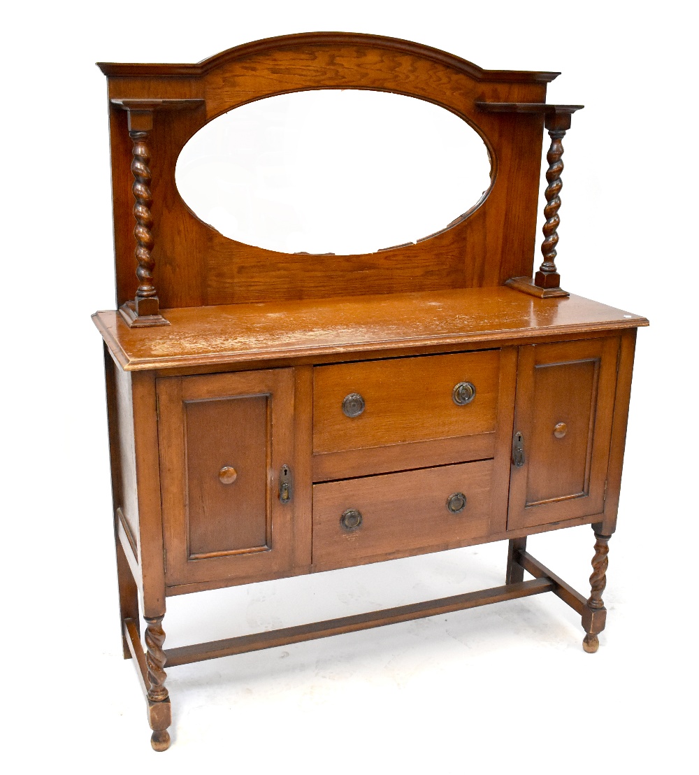 An early/mid-20th century oak mirror back sideboard with barleytwist supports,