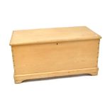 A 20th century stripped pine blanket box to shaped plinth support, length 93cm.