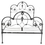 A Victorian-style gilt heightened black painted wrought iron double bedstead,