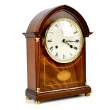 Comitti of London; a modern arched top mahogany-cased chiming mantel clock in the Regency style,