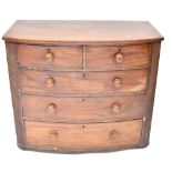 A Victorian mahogany bow-front two-over-three chest of drawers with decorative pillar to either