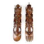 A large pair of 20th century carved wall hangings,