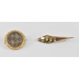 A 19th century 9ct gold circular mourning brooch with woven hair in a floral cut border and engine