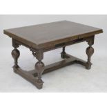 An early 20th century oak draw-leaf refectory table to baluster supports and cross stretchers,