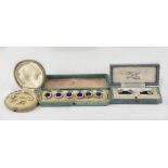 Three cased sets to include a set of six blue enamelled centres within a cream border,