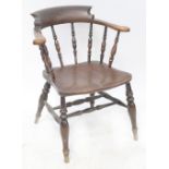 A 19th century provincial captain-style Windsor armchair with spindle supports,
