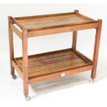 A teak two-tier tea trolley made from reclaimed timber by Hughes Bolckow Ship Breaking Co Ltd,