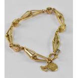 An Edwardian hallmarked 18ct gold fancy link bracelet with safety chain and later added small