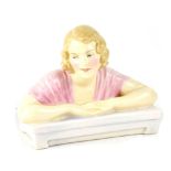 A Royal Doulton figurine HN1741 'Gladys', a young lady with arms resting on a desk, height 13cm.