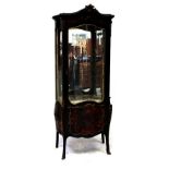 A late 19th century ebonised and scarlett boulle display cabinet with serpentine glazed front and