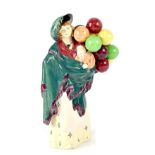 An early Royal Doulton figurine HN583 'Balloon Seller', lady balloon seller with baby in wrap,