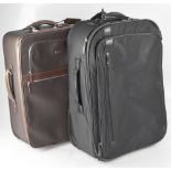 Two Tumi two-wheeled carry-on luggage cases to include one brown leather example, 55 x 42 x 24cm,