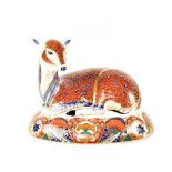 A Royal Crown Derby Imari paperweight in the form a deer laying on an oval base, silver stopper,