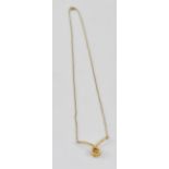 A 9ct gold necklace with rope twist pendant holding a tiny diamond within the knot,