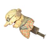 A late 19th/early 20th century tin plate mechanical toy of an elderly lady wearing glasses with bun,