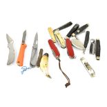 A quantity of small folding pocket knives to include Victorinox, a horn example with plated mounts,