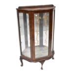 A mid-20th century rosewood glazed display cabinet with printed motif, on cabriole legs,