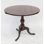 A 19th century mahogany tilt-top circular table, on vase column supported by three splayed feet,