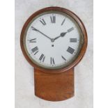 An early 20th century oak school/station wall hanging clock, the white dial set with Roman numerals,