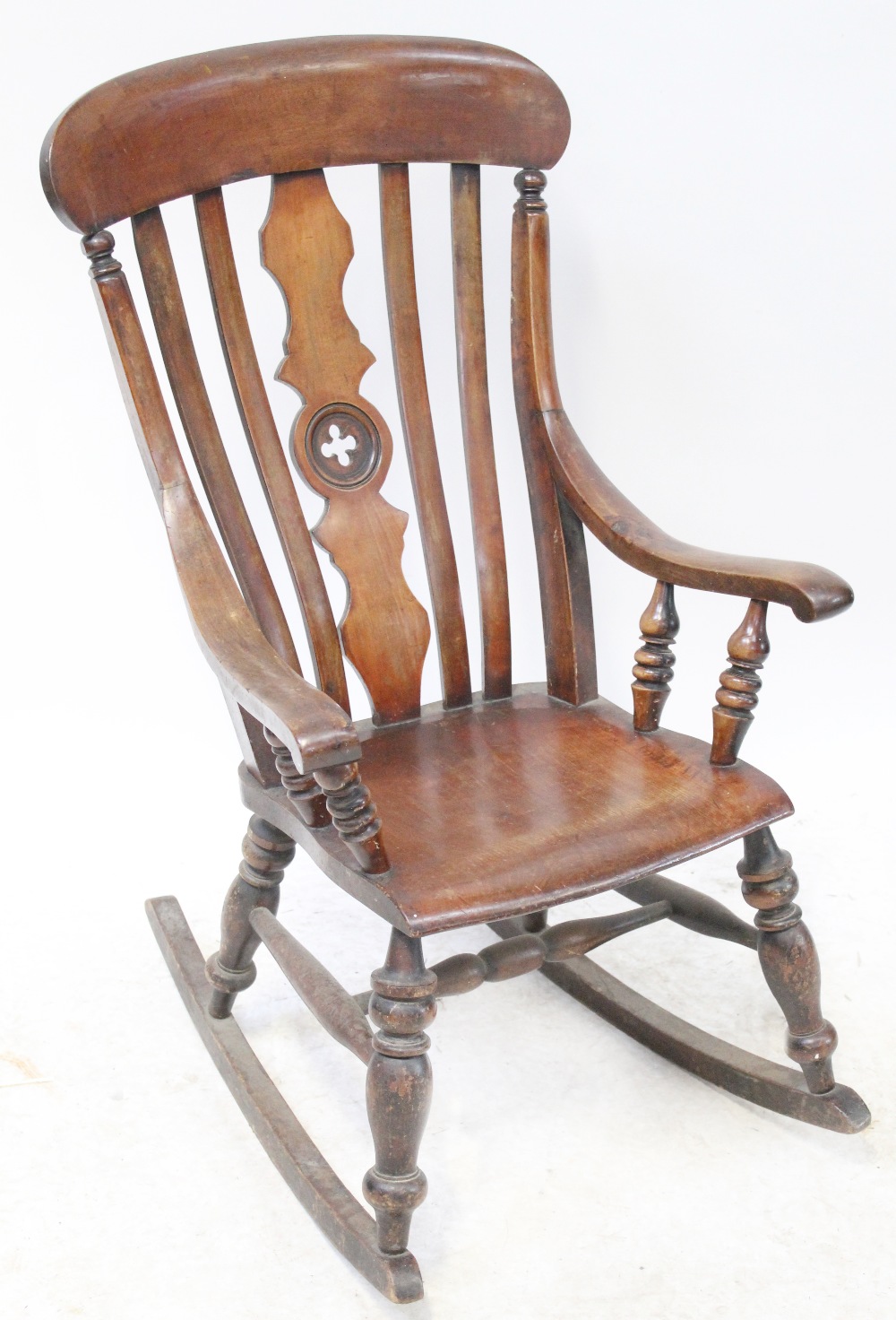 A 19th century provincial Windsor rocking chair with slatted back, sweeping arms,