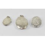 Three hallmarked silver oval double lockets, the largest with chased floral decoration is 5.