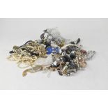 Various mixed costume jewellery to include gold hoop earrings, compact, badges and brooches,