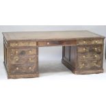 A large Victorian walnut partner's desk, with amber and gilt tooled leather insert top,