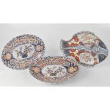 Two Meiji period Japanese Imari palette oval plates with floral decoration and central cartouche of