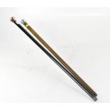 A black lacquered walking cane with silver bulbous handle with copper tones,
