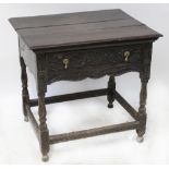 A late 18th century carved oak side table with plank top and single frieze,