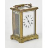 An early 20th century French brass carriage clock, the white dial set with Roman numerals,