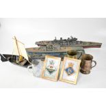 Two model Royal Naval war ships, a small model of a fishing boat, plated tankard with fish handle,