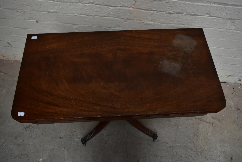 A reproduction mahogany veneered fold-over card table, raised on baluster from supports - Image 2 of 4