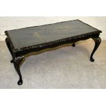 A mid-20th century black lacquered rectangular coffee table with chinoiserie decoration, raised on