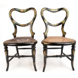 A pair of Victorian lacquered papier mache children's chairs decorated throughout with gilt and