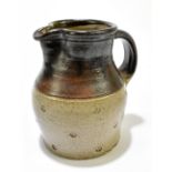 A stoneware jug with impressed decoration, height 15.5cm. Additional InformationAppears good with no