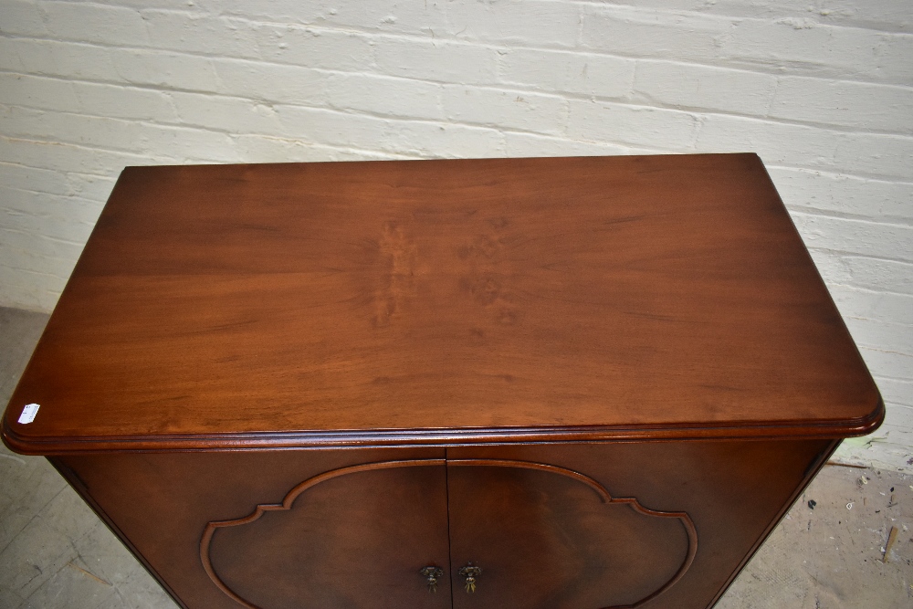 WARING & GILLOWS; a mahogany twin door cupboard raised on cabriole supports, length 100cm, depth - Image 2 of 4