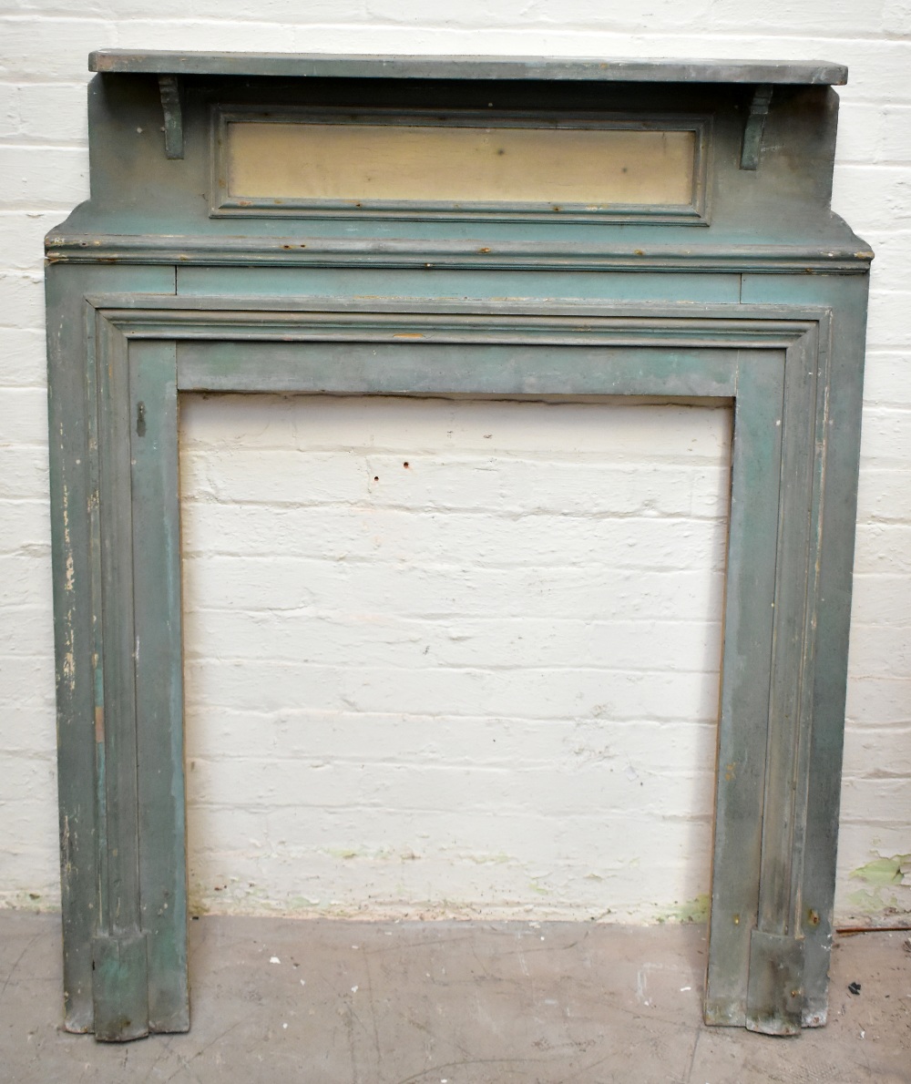 A 19th century green painted pine fire surround, height 138cm, width 113cm.