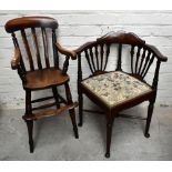 A 19th century elm seated child's high chair, raised on turned column supports, and an Edwardian