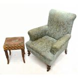 A Victorian club-type chair in the manner of Howard & Sons, with green floral upholstery, on