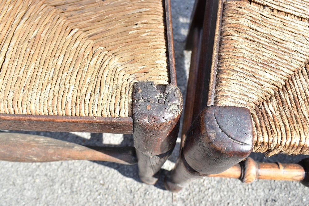 A harlequin set of six 19th century and later rush seated spindle back dining chairs, raised on - Image 4 of 4