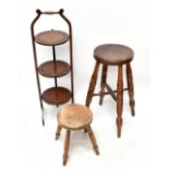 A 19th century elm stool, raised on turned column supports, together with a similar smaller