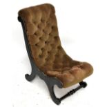 A 19th century ebonised slipper chair with upholstered back and seat and applied brass detail on