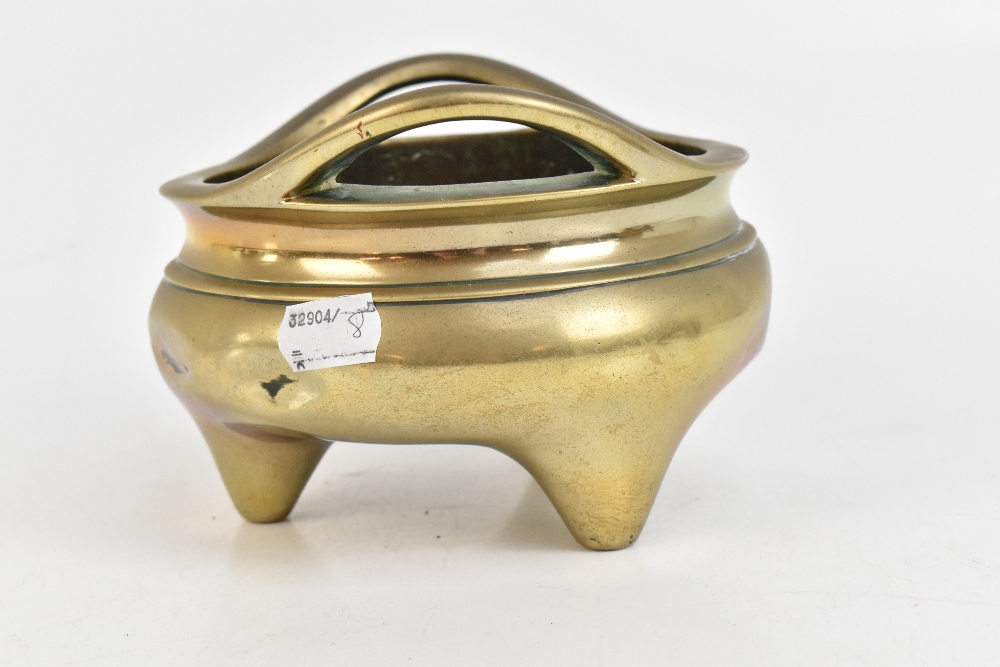 A Chinese bronze censer with pierced twin raised handles and three simple tapering supports, - Image 4 of 7