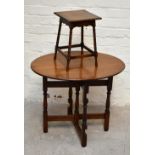 An early 20th century oak folding oval table, with turned legs, height 62cm, length 74cm, width