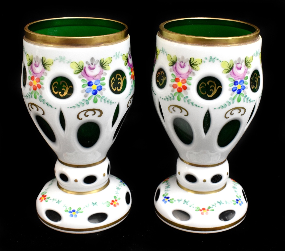 A pair of late 19th century Bohemian opaque flashed green glass vases, with cut detailing and