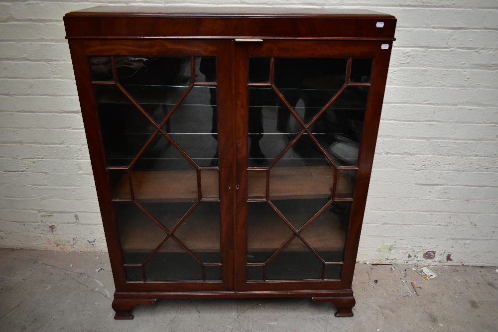 An early 20th century mahogany bookcase, the pair of astragal glazed doors, enclosing an arrangement - Image 2 of 3